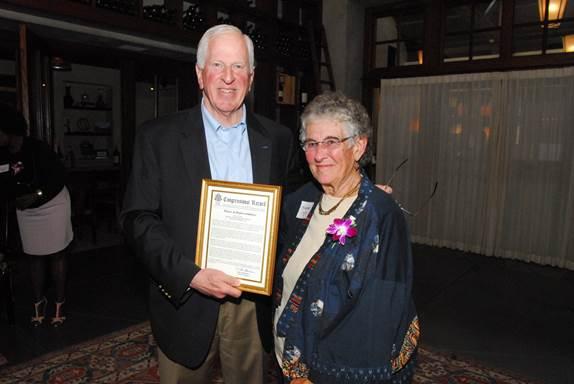 Rep. Thompson presents a certificate of Congressional recognition to Lyon.