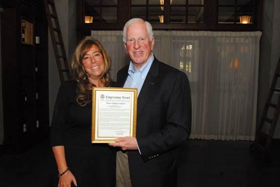 Rep. Thompson presents a certificate of Congressional recognition to Rubinoff.