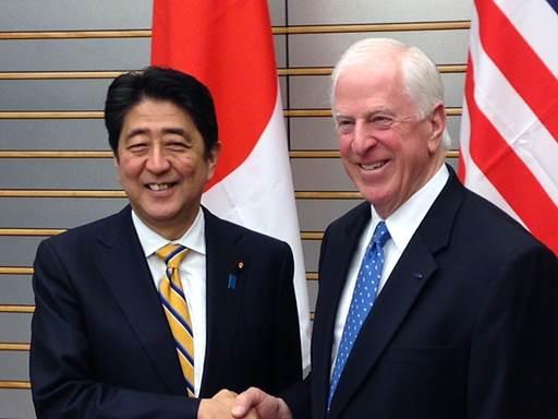 Thompson shakes hands with Prime Minster Abe in Japan.