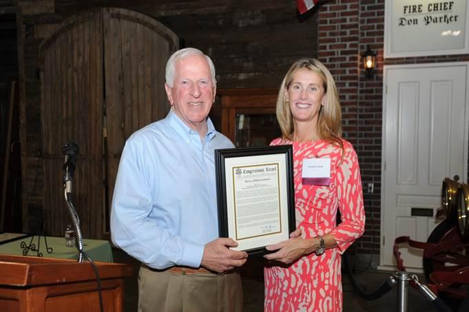 Thompson presents the award to Suzanne Smith.